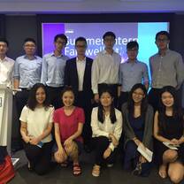 interns from internship in china program happily taking photos with co-workers in the office