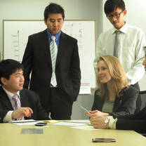 Marketing intern from GAC's internship in China program hasing a meeting with co-workers in the conference room