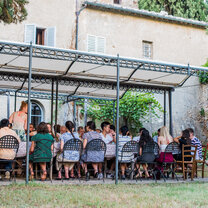 Group eating a meal outside at Spannocchia