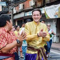 Teacher and student laugh in a street festival