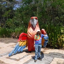 Man standing with giant fake parrot