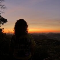 Trilha Alvarado Remember my funny story that might not have been so funny to you? Here is the picture proof I made it to the top of the trail and watched the sun kiss the mountains and paint the sky as it rose at approximately 6:15am. The big random shadow you could see on the far left is a shadow of my head as well as some trees poking out form the forest.