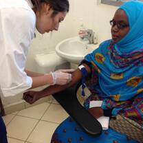 PA healthcare participant attending to a patient in our placement center in Mombasa, Kenya at the CPGH.