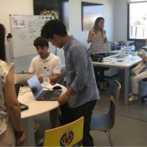 Interns sit around a table in Spain
