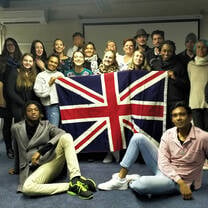 Graduates pose in front the British flag in Cape Town