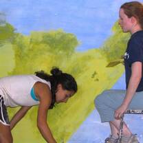 Volunteers decorating class-room walls.