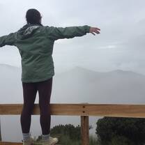 Standing on the railing on top of the Teleferico. 