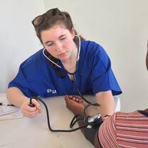 Participant taking blood pressure during high school abroad.
