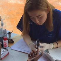 Participant taking blood sugar tests during high school abroad