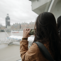 Student on the London Eye, taking a photo of Big Ben