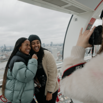 2 students on the London Eye, posing for a photograph 
