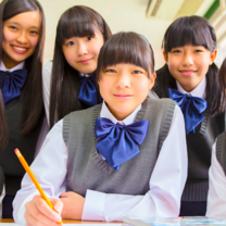 group of students wearing school uniforms with blue bows
