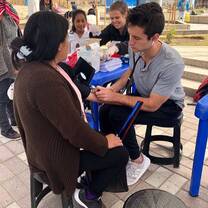 A volunteer taking blood pressure on a health campaign. 