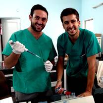 Two volunteers helping with treatments