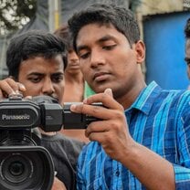 Young men using video camera