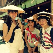 American girl with Japanese host sisters wearing traditional hats