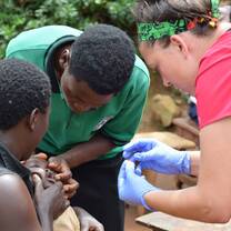 Volunteers providing vitamins to the children of Bududa.
