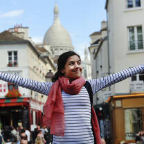 Girl with arms outstretched, taking in the beauty of France