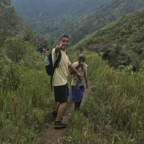 A volunteer hiking to the beautiful views of Bududa. 