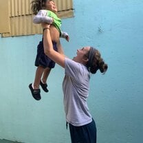 A volunteer having fun with children at the clinic!