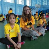 Young girl and teacher sitting and smiling