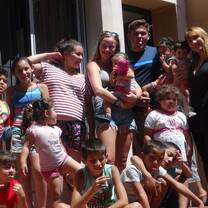 Volunteers together with children and project staff smiling to the camera