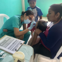 A volunteer distributing vitamins to the children in our nutrition program. 