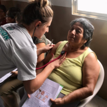 A volunteer taking vitals at a health fair. 