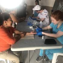 A volunteer helping to take glucose levels. 