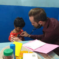 A volunteer taking vitals at a creche. 
