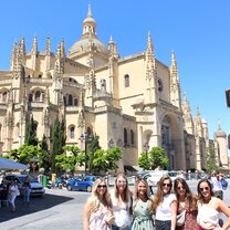 Group of girls in front of an intricate Basilica in Segovia