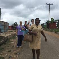 Five people walking down street