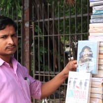 A local bookseller posing with Michelle Obama's novel.