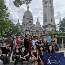 Students sitting in front of Paris landmarks