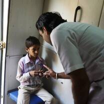 Medical volunteer in India working with a child.