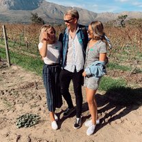 A picture with two of my friends during a wine tasting adventure in the Cape Town wine country.