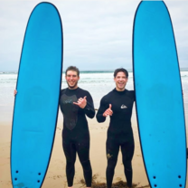 Stepabroad participants holding their surfboards after a surf lesson