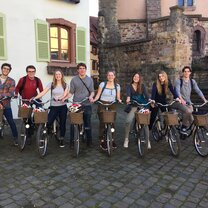 A group of students biking through Colmar on a weekend getaway.