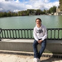 Sitting in front of the pond in the middle of Retiro Park
