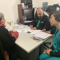 I am speaking with a patient in Spanish so that I can translate her problems to the American doctor