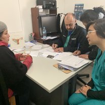 I am speaking with a patient in Spanish so that I can translate her problems to the American doctor