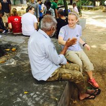 Volunteering at the Relief settlement and playing hand games with one of the men there