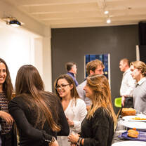 Group of people engaging each other in a mixer