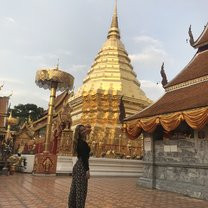 Me standing in front of a beautiful gold Buddhist temple. 