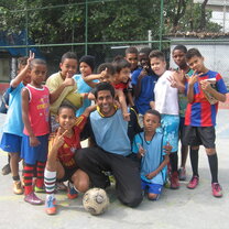 Volunteer with children at a football court Sports Development volunteering in Rio de Janeiro