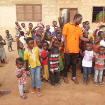 The Founder and President of CCHC in a picture of Abodo children. He went there as a follow up of the project.