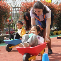 Kids playing with wheel barrow in Suzhou, China