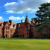 Building with blue sky and green lawn