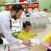 Teacher Eslam working with a Chinese girl during his TEFL program.