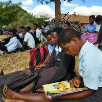 A young girl excited about reading in Kenya.